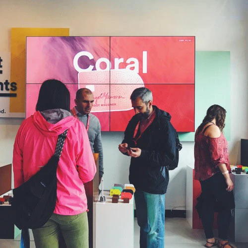 Attendees exploring the Coral card display at the Capital One House