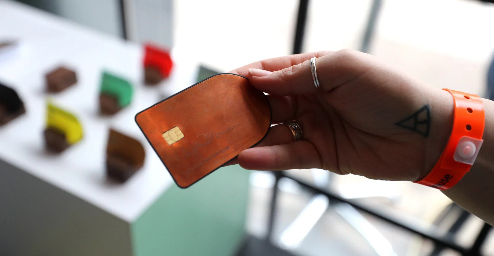 An SXSW attendee holding a copper-finish Project Elements card